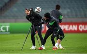 8 October 2021; Callum Robinson, Troy Parrott, behind, and videographer Matty Turnbull are targets of a kicked ball as they record footage during a Republic of Ireland training session at the Olympic Stadium in Baku, Azerbaijan. Photo by Stephen McCarthy/Sportsfile