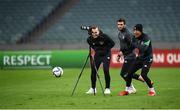 8 October 2021; Callum Robinson, right, Troy Parrott, centre, and videographer Matty Turnbull are targets of a kicked ball as they record footage during a Republic of Ireland training session at the Olympic Stadium in Baku, Azerbaijan. Photo by Stephen McCarthy/Sportsfile