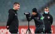 8 October 2021; Callum Robinson records footage of team-mates as manager Stephen Kenny walks by during a Republic of Ireland training session at the Olympic Stadium in Baku, Azerbaijan. Photo by Stephen McCarthy/Sportsfile