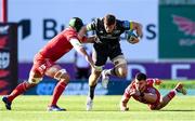 10 October 2021; Jack O’Donoghue of Munster evades the tackles of Morgan Jones and Johnny Williams of Scarlets during the United Rugby Championship match between Scarlets and Munster at Parc Y Scarlets in Llanelli, Wales. Photo by Ben Evans/Sportsfile