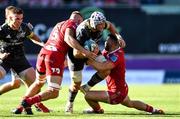 10 October 2021; Fineen Wycherley of Munster is tackled by Johnny Williams and Lloyd Ashley of Scarlets during the United Rugby Championship match between Scarlets and Munster at Parc Y Scarlets in Llanelli, Wales. Photo by Ben Evans/Sportsfile