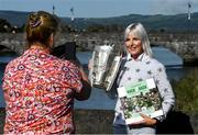 11 October 2021; Maria Croke O'Sullivan holds the Liam MacCarthy cup as she is photographed by her Limerick City and County Council colleague Yvonne Daly at the launch of 'Back 2 Back' at Limerick City and County Council offices at Merchants Quay in Limerick. Photo by Ray McManus/Sportsfile