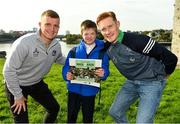 11 October 2021; Fergal Archer, 5th class student in Our Lady Queen of Peace Primary School, after receiving a gift of a book from Limerick hurlers Peter Casey, left, and William O'Donoghue at the launch of 'Back 2 Back' at Limerick City and County Council offices at Merchants Quay in Limerick. Photo by Diarmuid Greene/Sportsfile