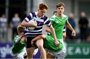 6 October 2021; Simon Horgan of Terenure College is tackled by Tom Lynn, left, and Luke McLoughlin of Gonzaga College during the Bank of Ireland Leinster Schools Junior Cup Round 2 match between Gonzaga College and Terenure at Energia Park in Dublin. Photo by Piaras Ó Mídheach/Sportsfile
