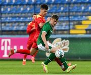 12 October 2021; Gavin Kilkenny of Republic of Ireland in action against Milan Vukotic of Montenegro during the UEFA European U21 Championship Qualifier Group F match between Montenegro and Republic of Ireland at Gradski Stadion Podgorica in Podgorica, Montenegro. Photo by Filip Roganovic/Sportsfile