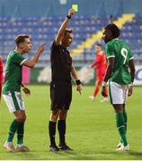 12 October 2021; Joshua Ogunfaolu-Kayode of Republic of Ireland is shown a yellow card by referee Barbeno Luca during the UEFA European U21 Championship Qualifier Group F match between Montenegro and Republic of Ireland at Gradski Stadion Podgorica in Podgorica, Montenegro. Photo by Filip Roganovic/Sportsfile