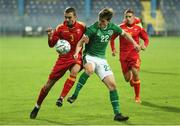 12 October 2021; Colm Whelan of Republic of Ireland in action against Andrija Ražnatovic of Montenegro during the UEFA European U21 Championship Qualifier Group F match between Montenegro and Republic of Ireland at Gradski Stadion Podgorica in Podgorica, Montenegro. Photo by Filip Roganovic/Sportsfile