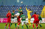 12 October 2021; Montenegro goalkeeper Nikola Ivezic and Mark McGuinness of Republic of Ireland compete for possession during the UEFA European U21 Championship Qualifier Group F match between Montenegro and Republic of Ireland at Gradski Stadion Podgorica in Podgorica, Montenegro. Photo by Filip Roganovic/Sportsfile