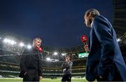 12 October 2021; Republic of Ireland manager Stephen Kenny, watched by FAI communications executive Kieran Crowley, is interviewed by television before the international friendly match between Republic of Ireland and Qatar at Aviva Stadium in Dublin. Photo by Stephen McCarthy/Sportsfile