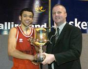 24 March 2004: St. Fintan's captain Isaac Westbrooks is presented with the cup by Martin Hehir, Schools Development Officer of Basketball Ireland. All-Ireland Schoolboys Basketball League, U19 'A'  Final, St FIntan's, Sutton, Dublin v North Monastery, Cork, ESB Arena, Tallaght, Dublin. Picture credit; Brendan Moran / SPORTSFILE *EDI*