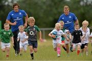 24 July 2013; Five year old Roisin Kinch, with the ball, from Tullow, Co. Carlow, with Leinster's Mike McCarthy, left, and Jordi Murphy and children at the Leinster Rugby Summer Camp at Tullow RFC. Tullow RFC, Tullow, Co. Carlow. Picture credit: Matt Browne / SPORTSFILE