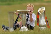 24 July 2013; Seven year old James Hayden, from Bagenalstown, Co. Carlow, with, from left, the British & Irish Cup, Amlin Challenge Cup, and the Rabodirect Pro12 Cup during a Leinster Rugby Summer Camp at Tullow RFC. Tullow RFC, Tullow, Co. Carlow. Picture credit: Matt Browne / SPORTSFILE