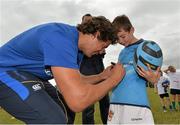 24 July 2013; Leinster's Mike McCarthy autographs the shirt of Patrick Doyle, from Tullow, Co. Carlow, during a Leinster Rugby Summer Camp at Tullow RFC. Tullow RFC, Tullow, Co. Carlow. Picture credit: Matt Browne / SPORTSFILE