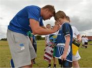 24 July 2013; Leinster's Jordi Murphy autographs the shirt of Diarmuid Burrows, from Tullow, Co. Carlow, during a Leinster Rugby Summer Camp at Tullow RFC. Tullow RFC, Tullow, Co. Carlow. Picture credit: Matt Browne / SPORTSFILE