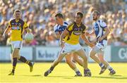 20 July 2013; Daithi Waters, Wexford, in action against John O'Loughlin, Laois. GAA Football All-Ireland Senior Championship Round 3, Wexford v Laois, Wexford Park, Wexford Picture credit: David Maher / SPORTSFILE
