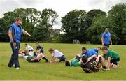 25 July 2013; Leinster coaches Tom McKeown, left, and Colm Finnegan instruct children during a drill at the Leinster School of Excellence. The King's Hospital, Palmerstown, Dublin. Picture credit: Barry Cregg / SPORTSFILE