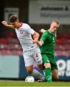 13 October 2021; Oliwier Slawinski of Poland is tackled by Cathal Heffernan of Republic of Ireland resulting in a penalty during the UEFA U17 Championship Qualifying Round Group 5 match between Republic of Ireland and Poland at Turner's Cross in Cork. Photo by Eóin Noonan/Sportsfile