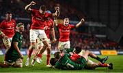 16 October 2021; Munster players celebrate as Diarmuid Barron of Munster, hidden, scores his side's second try despite the efforts of John Porch of Connacht, during the United Rugby Championship match between Munster and Connacht at Thomond Park in Limerick. Photo by David Fitzgerald/Sportsfile