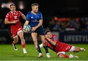 16 October 2021; Jordan Larmour of Leinster is tackled by Kieran Hardy of Scarlets during the United Rugby Championship match between Leinster and Scarlets at the RDS Arena in Dublin. Photo by Seb Daly/Sportsfile