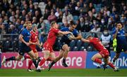 16 October 2021; James Lowe of Leinster is tackled by Johnny McNicholl, left, and Sam Costelow of Scarlets during the United Rugby Championship match between Leinster and Scarlets at the RDS Arena in Dublin. Photo by Ramsey Cardy/Sportsfile
