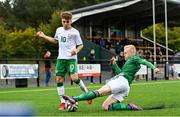 22 October 2021; Naz Raji of Republic of Ireland is tackled by Brendan Hamilton of Northern Ireland during the Victory Shield match between Northern Ireland and Republic of Ireland at Blanchflower Park in Belfast. Photo by Ramsey Cardy/Sportsfile