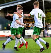 22 October 2021; Cian Mulvilhill of Republic of Ireland celebrates after scoring his side's first goal with team-mate Naz Raji, centre, and Luke Kehir, right, during the Victory Shield match between Northern Ireland and Republic of Ireland at Blanchflower Park in Belfast. Photo by Ramsey Cardy/Sportsfile