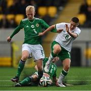 22 October 2021; Anthony Dodd of Republic of Ireland is tackled by Brendan Hamilton, left, and Cormac Austin of Northern Ireland during the Victory Shield match between Northern Ireland and Republic of Ireland at Blanchflower Park in Belfast. Photo by Ramsey Cardy/Sportsfile