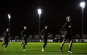22 October 2021; Dundalk players, from right, Greg Sloggett, Han Jeongwoo, Sam Stanton and Cameron Dummigan warm-up before the Extra.ie FAI Cup Semi-Final match between St Patrick's Athletic and Dundalk at Richmond Park in Dublin. Photo by Ben McShane/Sportsfile