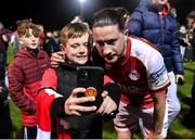 22 October 2021; Ronan Coughlan of St Patrick's Athletic takes a photograph with a young supporter after their side's victory over Dundalk the Extra.ie FAI Cup semi-final match between St Patrick's Athletic and Dundalk at Richmond Park in Dublin. Photo by Seb Daly/Sportsfile