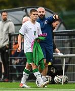 22 October 2021; Anthony Dodd of Republic of Ireland and kit and equipment manager Shane Elliott during the Victory Shield match between Northern Ireland and Republic of Ireland at Blanchflower Park in Belfast. Photo by Ramsey Cardy/Sportsfile