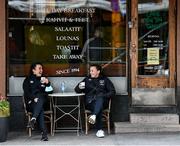 24 October 2021; Republic of Ireland players Niamh Farrelly, left, and Katie McCabe enjoy a coffee at Cafe Tin Tin Tango in Helsinki ahead of the team's FIFA Women's World Cup 2023 Qualifier against Finalnd on Tuesday. Photo by Stephen McCarthy/Sportsfile