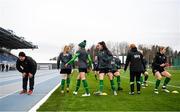 24 October 2021; Players go through their warm up as a member of the public takes a breather from a run during a Republic of Ireland Women training session at Leppavaara Stadium in Helsinki, Finland. Photo by Stephen McCarthy/Sportsfile
