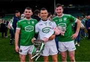 24 October 2021; Kilmallock goalkeeper Barry Hennessy, holding his sleeping daughter Hope, age 3 months, as he celebrates with team-mates Oisín O'Reilly, 11, and Phelim O'Reilly, 29, after the Limerick County Senior Club Hurling Championship Final match between Kilmallock and Patrickswell at TUS Gaelic Grounds in Limerick. Photo by Piaras Ó Mídheach/Sportsfile