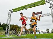 17 October 2021; Niall Murphy of Ennis Track AC, Clare, left, and Jonas Stafford of Ashford AC, Wicklow, cross the finish line after competing in the Junior Men's 6000m during the Autumn Open International Cross Country at the Sport Ireland Campus in Dublin. Photo by Sam Barnes/Sportsfile