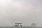 29 October 2021; The Shamrock Rovers and Finn Harps teams huddle together amid heavy smoke from flares in the stadium before the SSE Airtricity League Premier Division match between Shamrock Rovers and Finn Harps at Tallaght Stadium in Dublin. Photo by Eóin Noonan/Sportsfile Photo