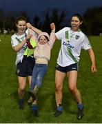 31 October 2021; Louise Ryan, left, and Leah Harrold celebrate with supporter Molly Dwyer after the Dublin LGFA Go-Ahead Intermediate Club Football Championship Final match between St Sylvesters and Castleknock at St Margarets GAA club in Dublin. Photo by Brendan Moran/Sportsfile