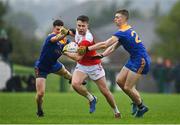 31 October 2021; Niall Daly of Pádraig Pearses in action against Jack Connaughton, left, and Sea Henry of Clann na nGael during the Roscommon County Senior Club Football Championship Final match between Clann na nGael and Padraig Pearses at Dr Hyde Park in Roscommon. Photo by Seb Daly/Sportsfile