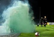 5 November 2021; Shamrock Rovers physiotherapist Tony McCarthy attempts to remove a flare from the dugout area during the SSE Airtricity League Premier Division match between Waterford and Shamrock Rovers at the RSC in Waterford. Photo by Seb Daly/Sportsfile
