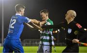 5 November 2021; John Martin of Waterford, left, and Kieran Cruise of Shamrock Rovers tussle as assistant referee Allen Lynch intervenes during the SSE Airtricity League Premier Division match between Waterford and Shamrock Rovers at the RSC in Waterford. Photo by Seb Daly/Sportsfile