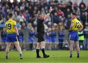 7 November 2021; David Lennon of St Mochta’s, left, looks on as match referee Derek Ryan issues a 'black card' to his team mate Danny Kindlon during the Louth County Senior Club Football Championship Final match between Naomh Mairtin and St Mochta’s at Páirc Mhuire in Ardee, Louth. Photo by Ray McManus/Sportsfile