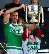 7 November 2021; Ballyhale Shamrocks captain Colin Fennelly lifts the Tom Walsh Cup with assistance from Jennifer Malone after the Kilkenny County Senior Club Hurling Championship Final match between Ballyhale Shamrocks and O'Loughlin Gaels at UPMC Nowlan Park in Kilkenny. Photo by Brendan Moran/Sportsfile