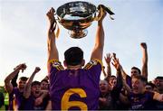 7 November 2021; Wolfe Tones captain Shane Glynn lifts the trophy in front of team-mates after their side's victory in the Meath County Senior Club Football Championship Final match between St Peter's Dunboyne and Wolfe Tones at Páirc Tailteann in Navan, Meath. Photo by Seb Daly/Sportsfile