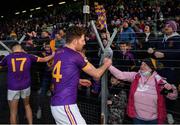 7 November 2021; Cian O’Neill of Wolfe Tones celebrates with supporters after their side's victory in the Meath County Senior Club Football Championship Final match between St Peter's Dunboyne and Wolfe Tones at Páirc Tailteann in Navan, Meath. Photo by Seb Daly/Sportsfile