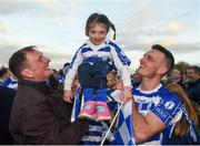 7 November 2021; Isla Doyle gets lifted in the cup after the game, by her grandad Niall O'Connor, who was centre back on the last Naas team to win the championship in 1990, and her dad Eoin Doyle of Naas after the Kildare County Senior Club Football Championship Final match between Naas and Sarsfields at St Conleth's Park in Newbridge, Kildare. Photo by Daire Brennan/Sportsfile