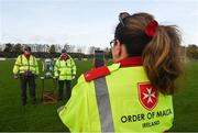 7 November 2021; Cora Duffy takes a picture of her Order of Malta colleagues Paddy Talt, left, and Adrian O'Brien with the Joe Ward Cup before the Louth County Senior Club Football Championship Final match between Naomh Mairtin and St Mochta’s at Páirc Mhuire in Ardee, Louth. Photo by Ray McManus/Sportsfile