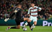 11 November 2021; Cristiano Ronaldo of Portugal is tackled by Republic of Ireland goalkeeper Gavin Bazunu during the FIFA World Cup 2022 qualifying group A match between Republic of Ireland and Portugal at the Aviva Stadium in Dublin. Photo by Seb Daly/Sportsfile