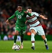 11 November 2021; Chiedozie Ogbene of Republic of Ireland is tackled by Diogo Dalot of Portugal during the FIFA World Cup 2022 qualifying group A match between Republic of Ireland and Portugal at the Aviva Stadium in Dublin. Photo by Eóin Noonan/Sportsfile
