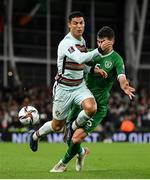 11 November 2021; Cristiano Ronaldo of Portugal is tackled by John Egan of Republic of Ireland during the FIFA World Cup 2022 qualifying group A match between Republic of Ireland and Portugal at the Aviva Stadium in Dublin. Photo by Seb Daly/Sportsfile