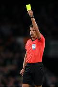11 November 2021; Referee Jesús Gil Manzano issues a yellow card during the FIFA World Cup 2022 qualifying group A match between Republic of Ireland and Portugal at the Aviva Stadium in Dublin. Photo by Stephen McCarthy/Sportsfile