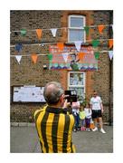 8 August 2021; Opportunity knocks. Kilkenny supporter Michael Gannon, from the Marble City, takes a photograph outside the house of Irish Olympic gold medallist Kellie Harrington on Portland Row. Earlier that morning Kellie’s exploits in the ring captured the hearts of the nation. Photo by Daire Brennan/Sportsfile This image may be reproduced free of charge when used in conjunction with a review of the book &quot;A Season of Sundays 2020&quot;. All other usage © Sportsfile